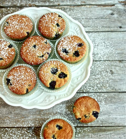 Blueberry cornmeal muffins on a white cakestand