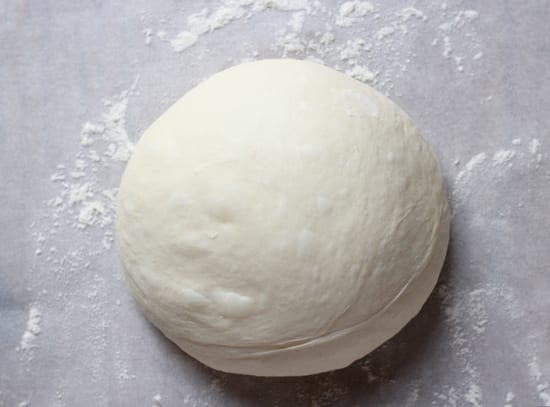 Shaped round bread dough on parchment paper