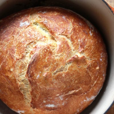 A loaf of no-knead artisan bread in a Dutch oven