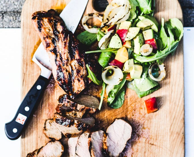 grilled pork tenderloin with wilted greens, sweet onions + peach vinaigrette | theclevercarrot.com