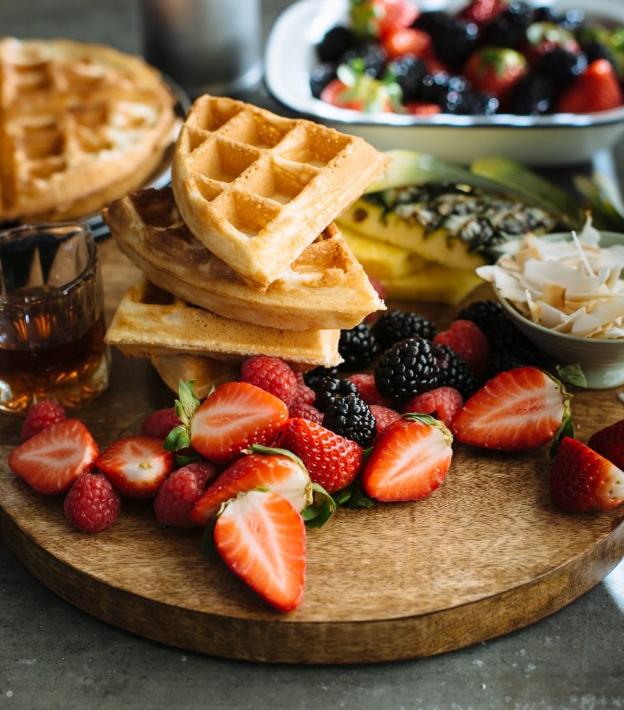 Stack of sourdough waffles with fruit. 