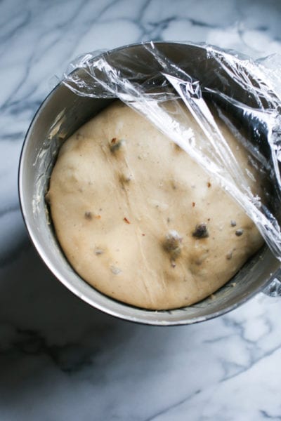 Stand mixer bowl with fully risen sourdough hot cross bun (dough).