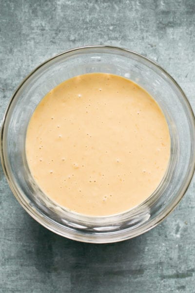 Sourdough banana bread batter with milk and oil mixed into the bowl