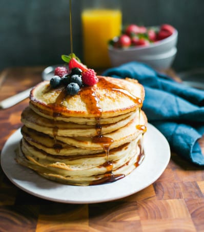 Stack of Fluffy Sourdough Pancakes with Maple Syrup | theclevercarrot.com