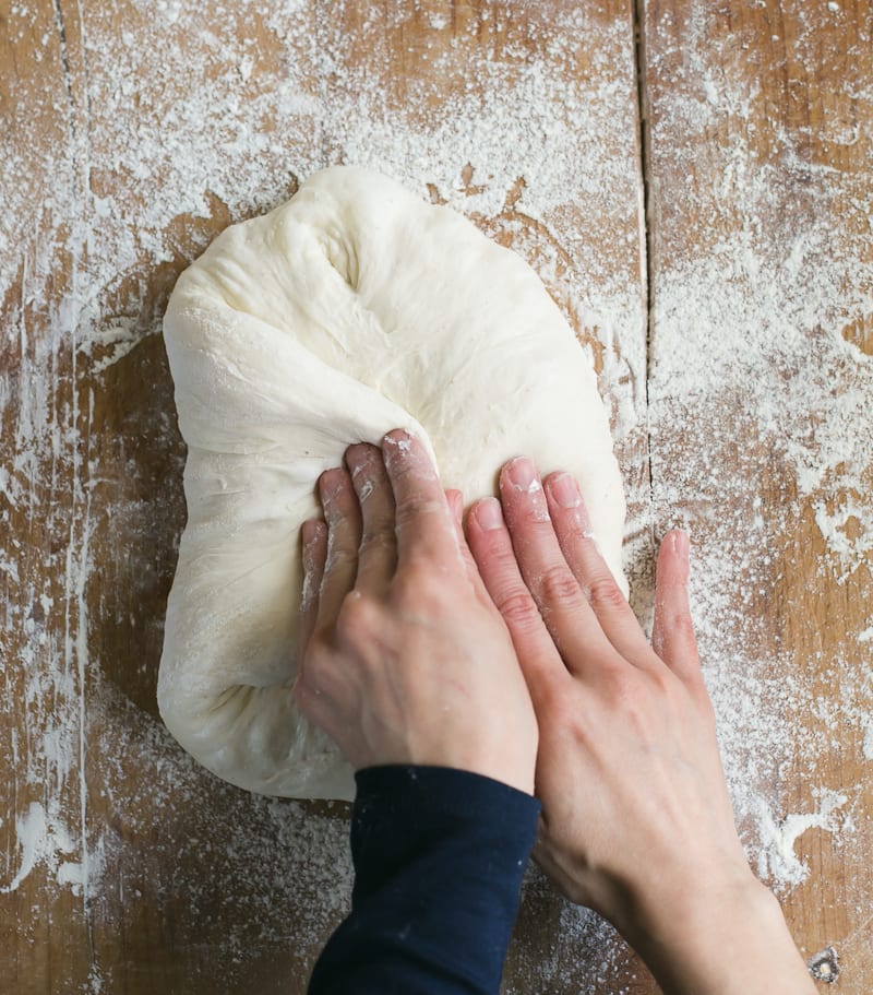 Stretching the dough to shape into a round