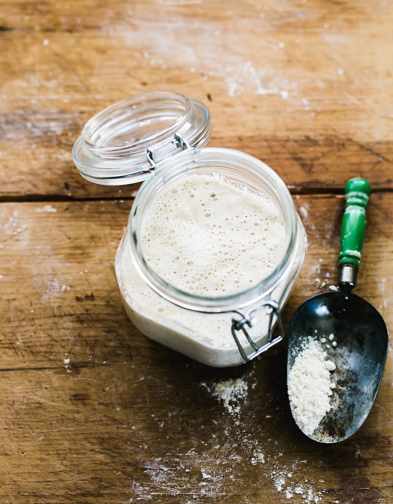 Jar of sourdough starter discard with a small spoon