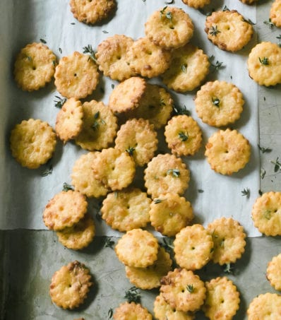 Tray of puffed sourdough crackers with gruyere, thyme and a rolling pin