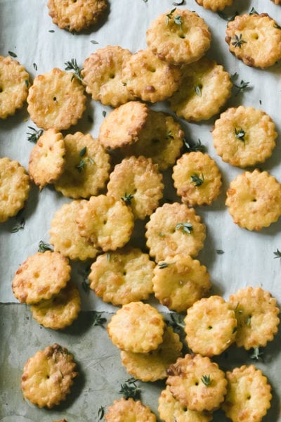 Tray of puffed sourdough crackers with gruyere, thyme and a rolling pin