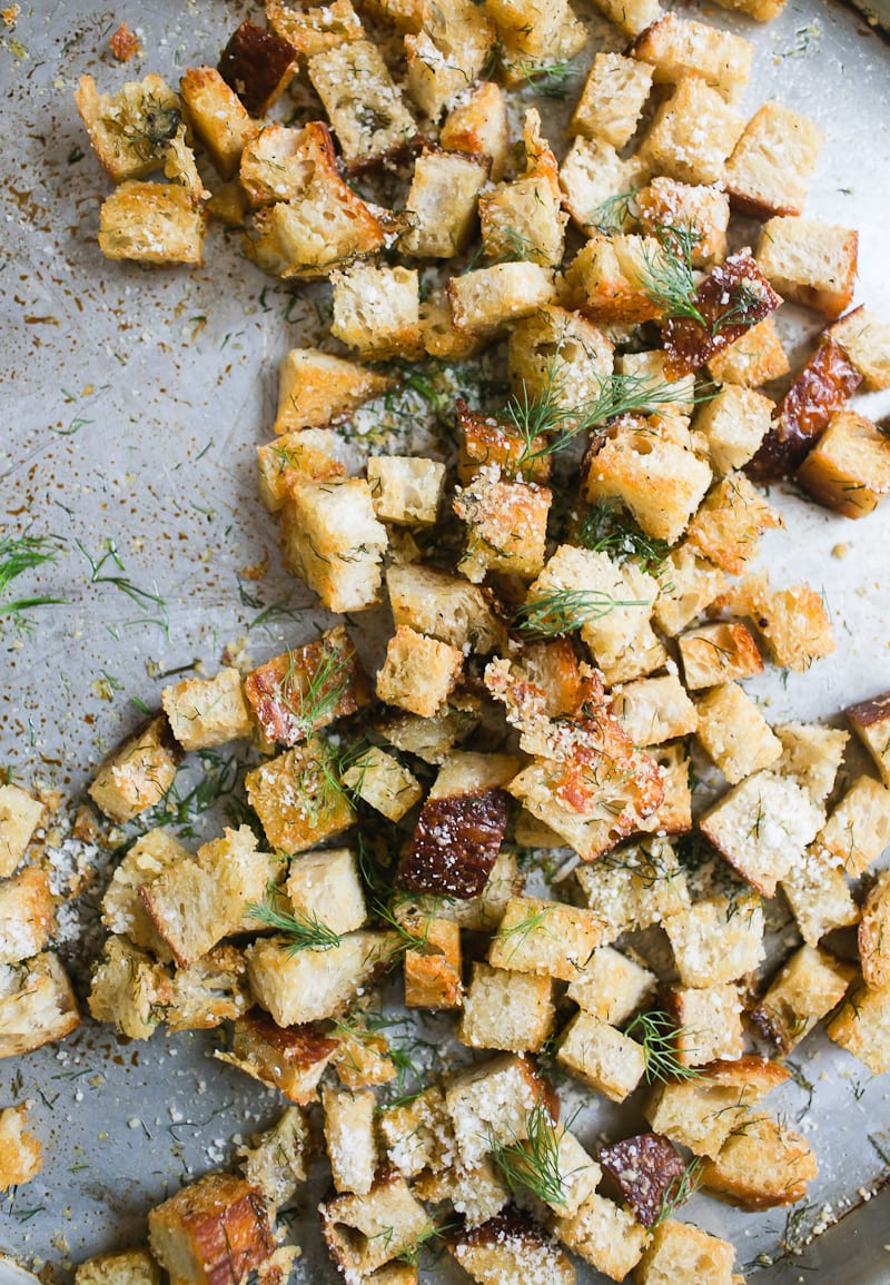 Tray of golden baked sourdough bread croutons with fresh herbs and parmesan cheese