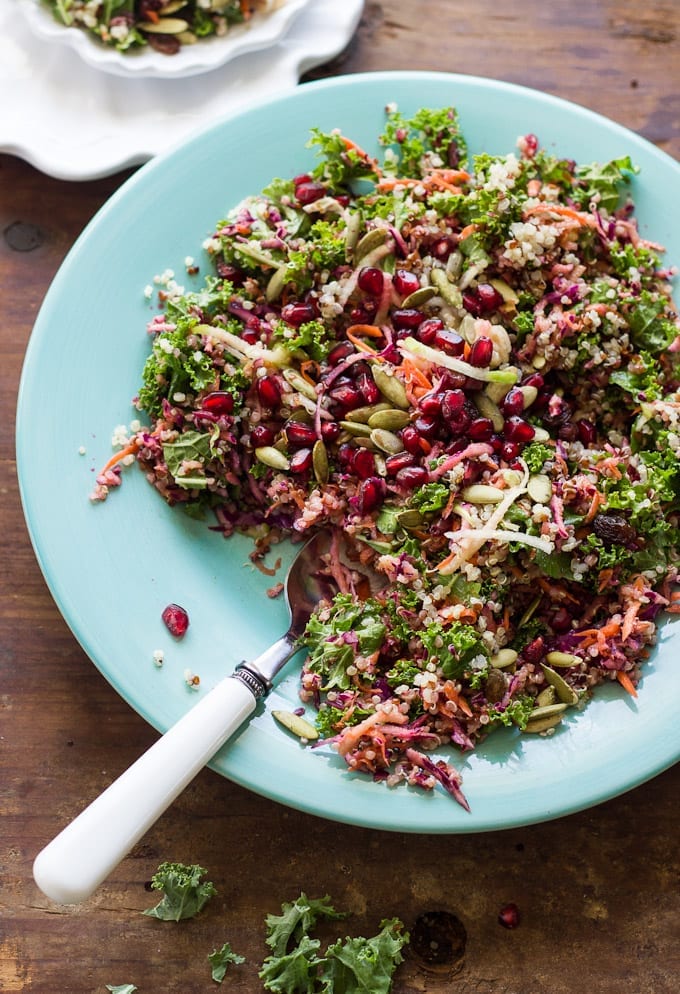 Blue plate with kale, red cabbage, pepitas, quinoa with ginger curry vinaigrette.