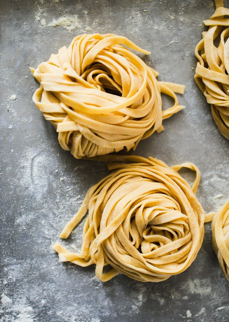 Coiled nests of homemade fresh pasta dough.