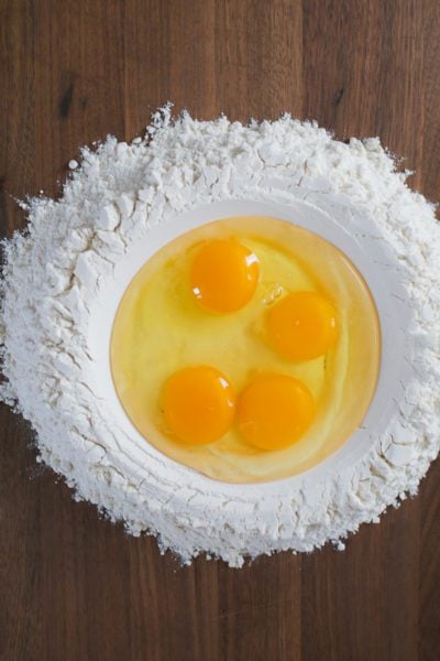 Eggs and flour on a wood board