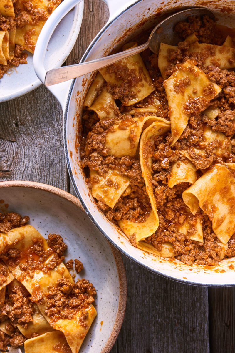 Fresh homemade pappardelle pasta with Ragù Bolognese sauce in serving bowls.