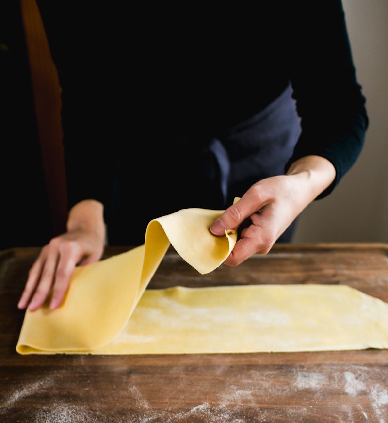 Folding a homemade pasta sheet in half