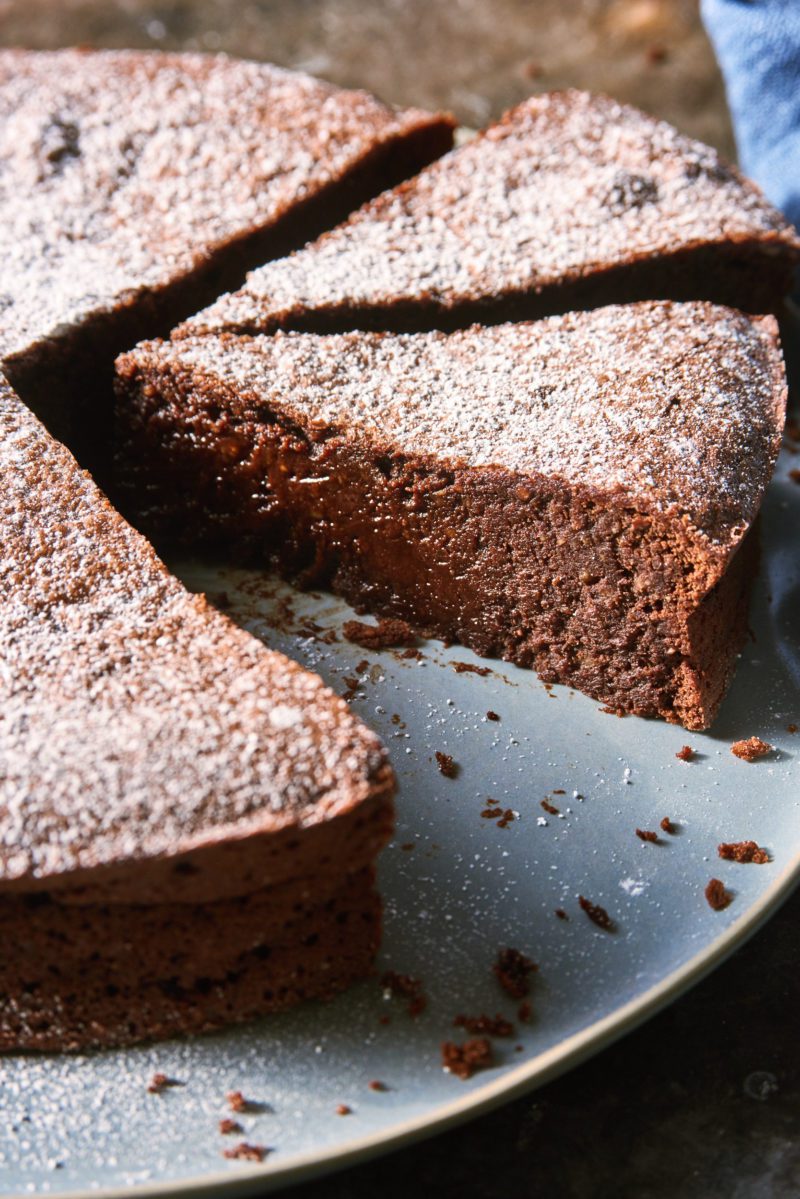 Torta Caprese (flourless chocolate almond cake) slices on a blue plate.