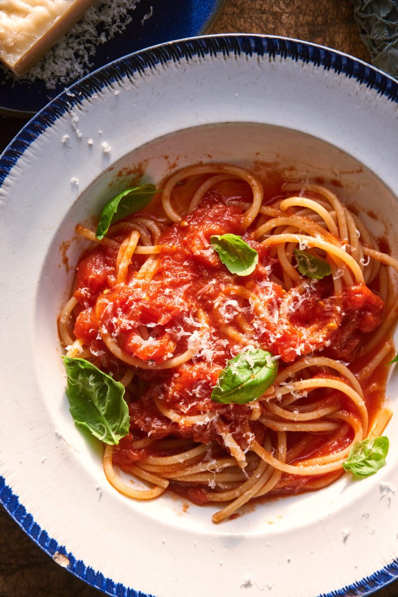 Spaghetti strands with homemade authentic Italian tomato sauce, basil and Parmesan cheese.