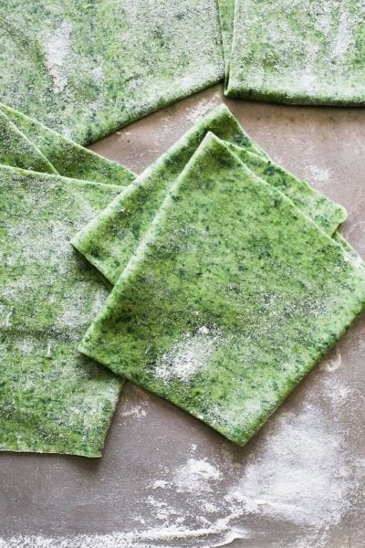 Spinach pasta dough rolled into sheets