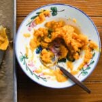 Roasted butternut squash in a bowl with flowers