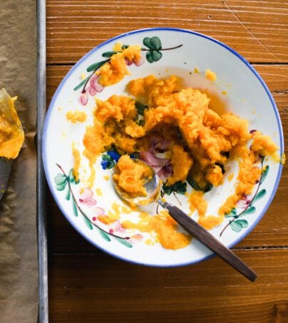 Roasted butternut squash in a bowl with flowers