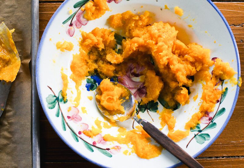 Roasted butternut squash in a bowl with flowers