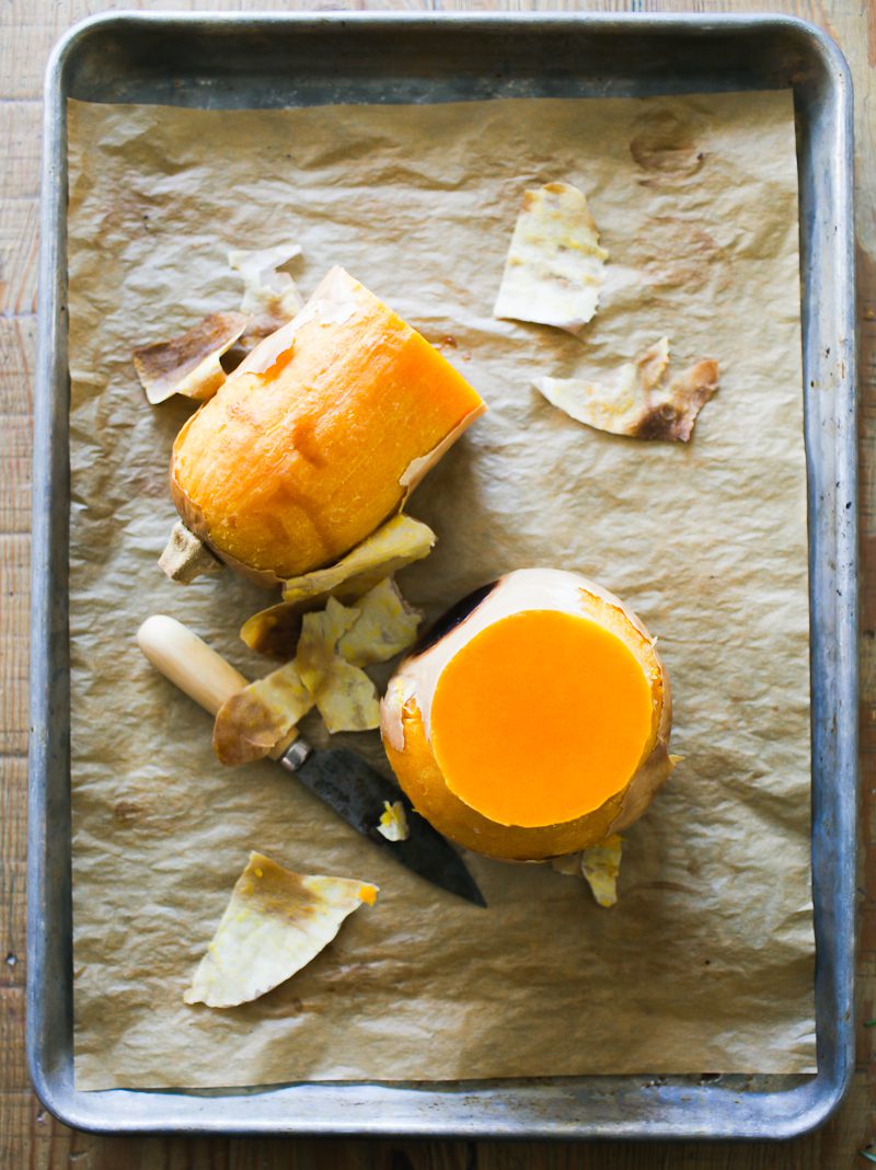 Whole-roasted butternut squash , halved, on a parchment-lined sheet pan