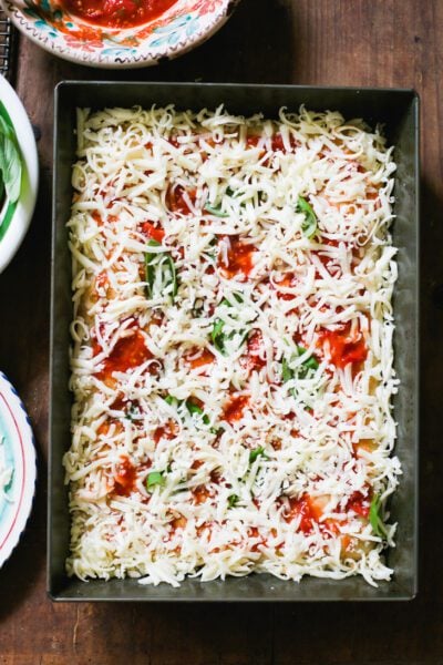 Assembled sourdough pizza in a 9x13-inch baking pan