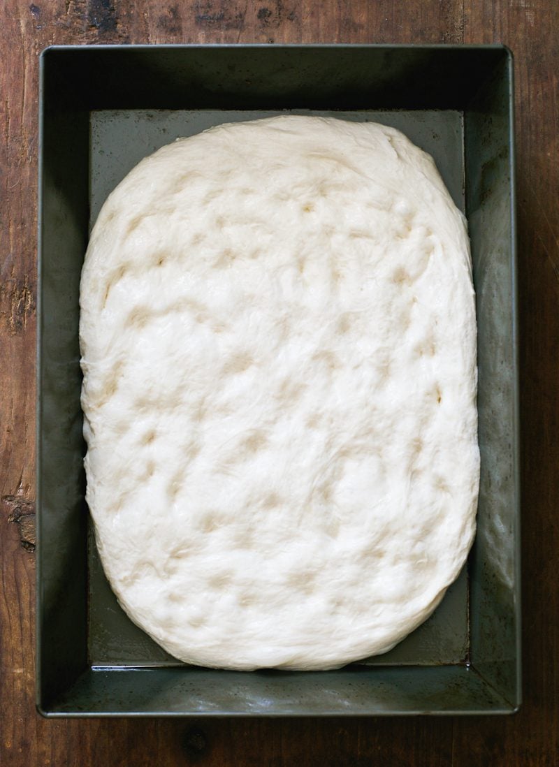 Sourdough pizza dough in a non-stick baking pan