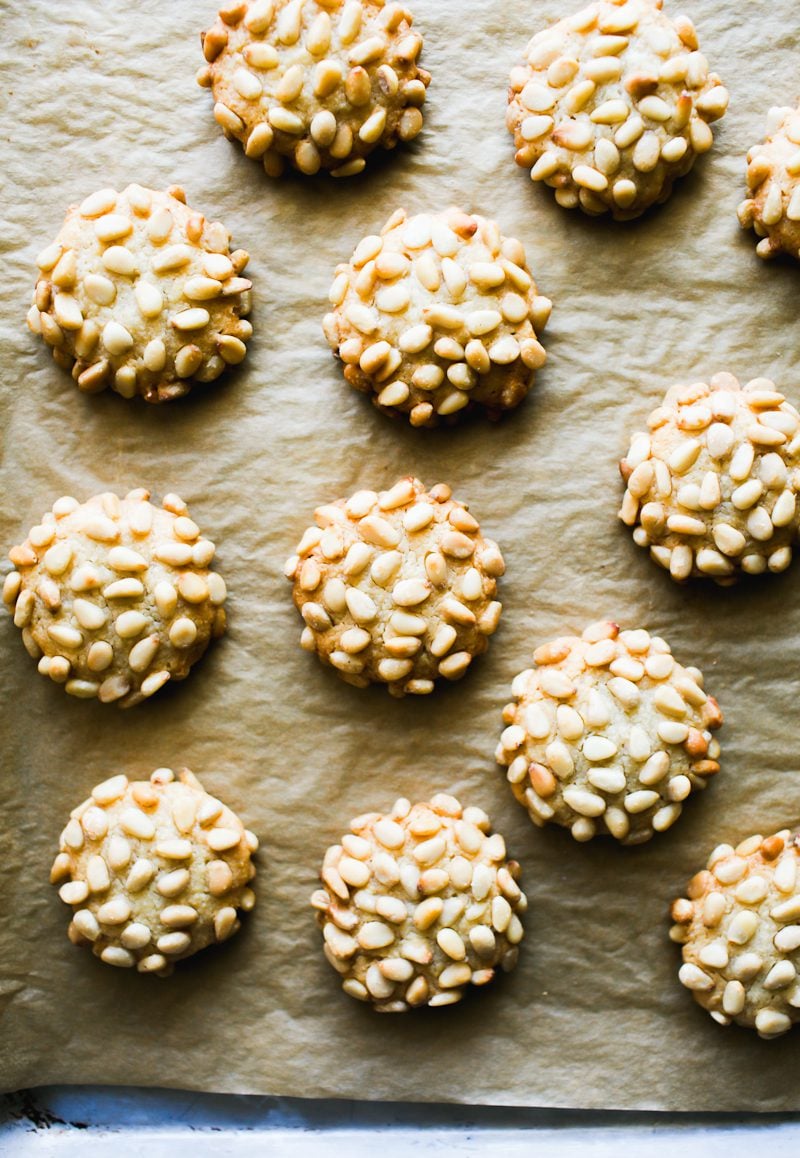 Pignoli cookies (Italian pine nut cookies) on a parchment-lined baking sheet