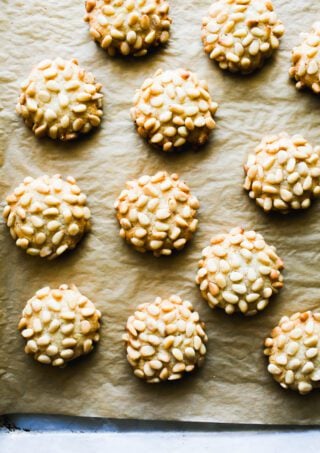 Pignoli cookies (Italian pine nut cookies) on a parchment-lined baking sheet