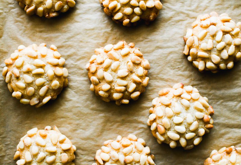 Pignoli cookies (Italian pine nut cookies) on a parchment-lined baking sheet