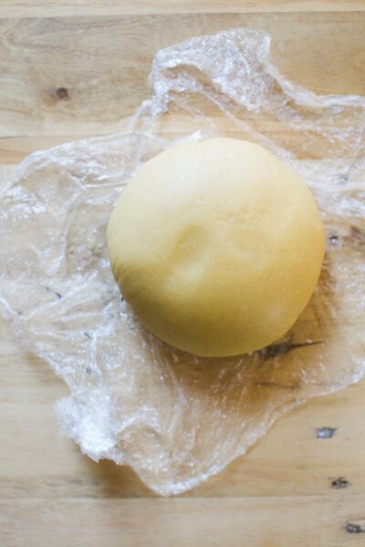 Ball of sourdough pasta dough in plastic wrao