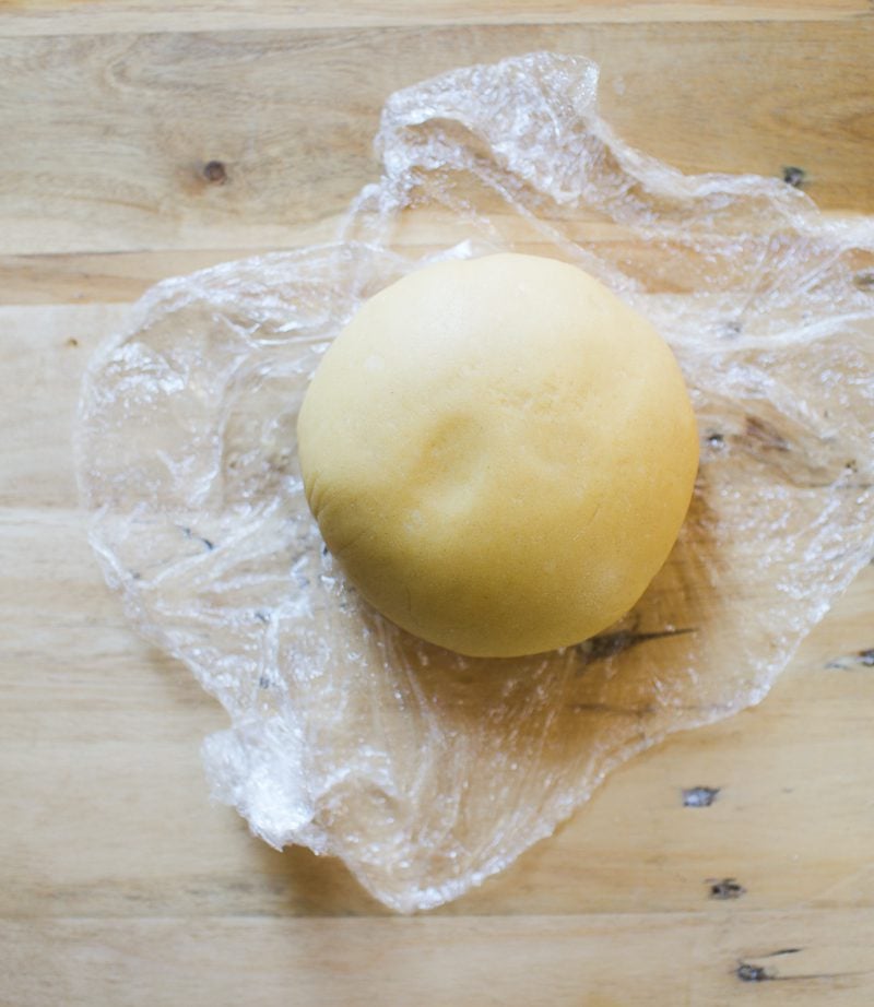 Ball of sourdough pasta dough in plastic wrao