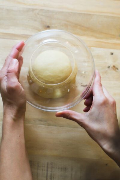 Sourdough pasta dough covered with an upturned bowl