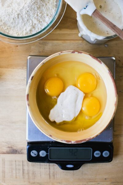Eggs and sourdough starter in a yellow bowl