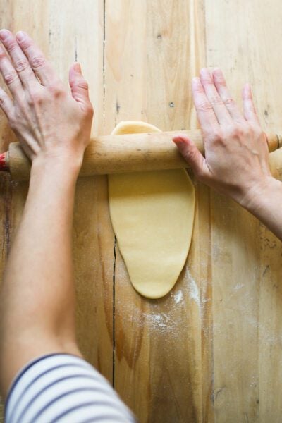 Rolling sourdough pasta dough with a rolling pin