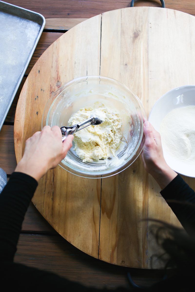 Scooping ricotta gnocchi dough with a cookies scoop