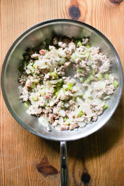 Cooked ground pork meat filling for ravioli in a skillet.