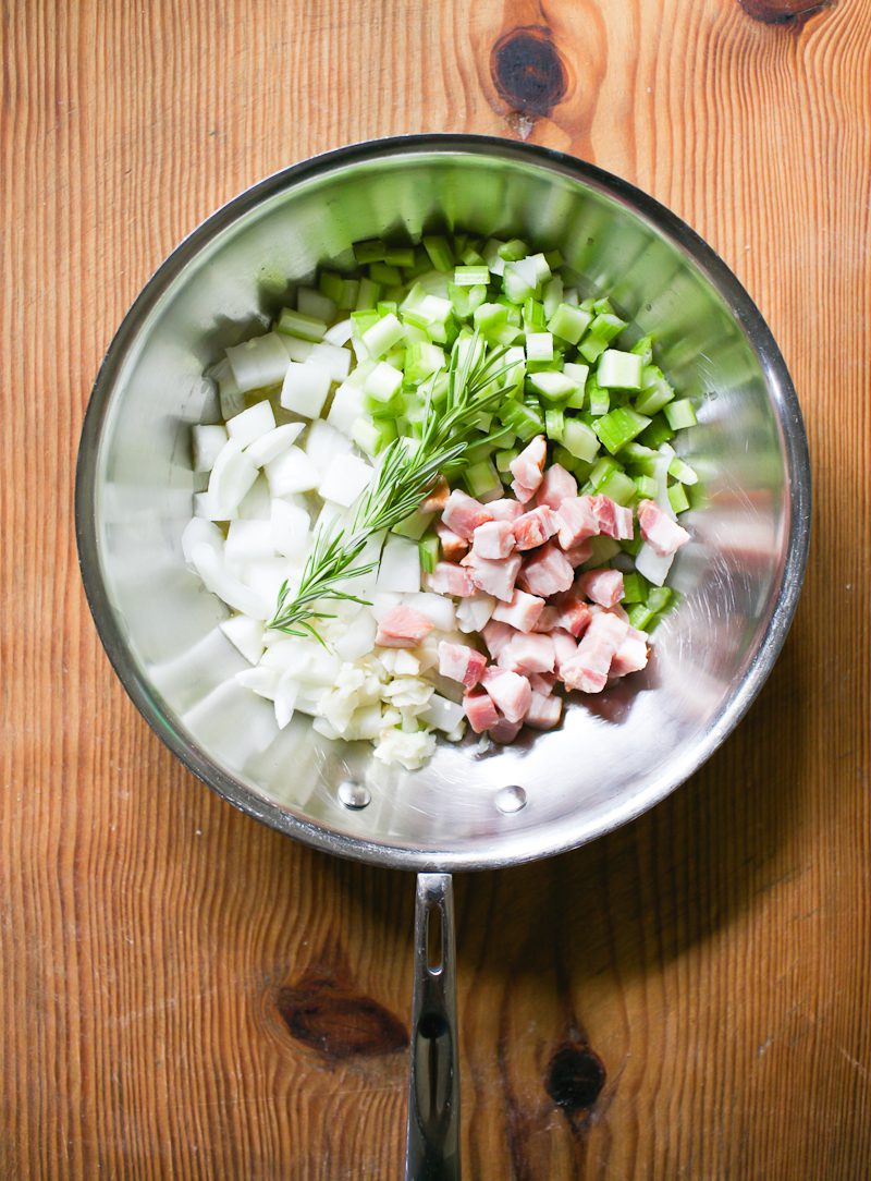 Diced bacon, onions, celery, garlic and rosemary in a skillet.