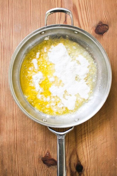 Melted butter in a skillet with floured sprinkled on top