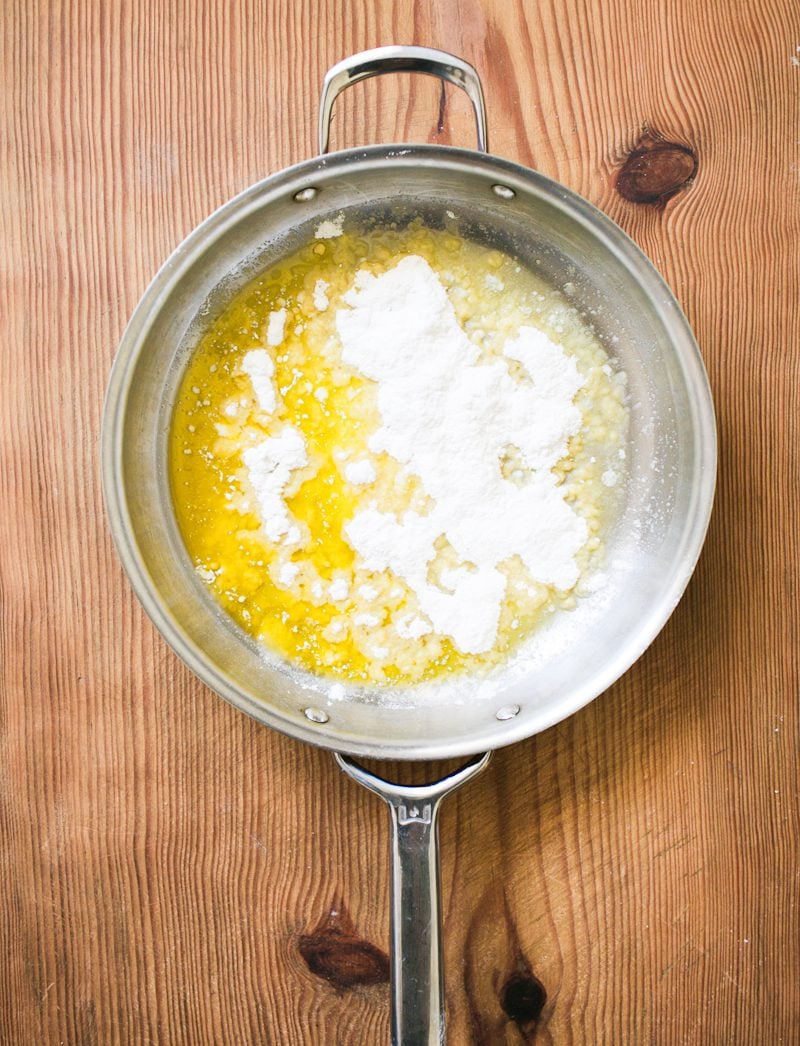 Melted butter in a skillet with floured sprinkled on top