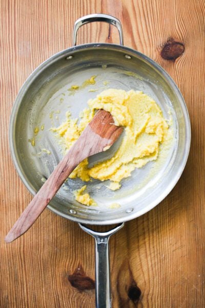 Mixed butter and flour in a skillet with a wooden spoon (roux)