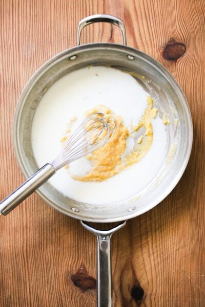 Blonde roux in skillet with milk
