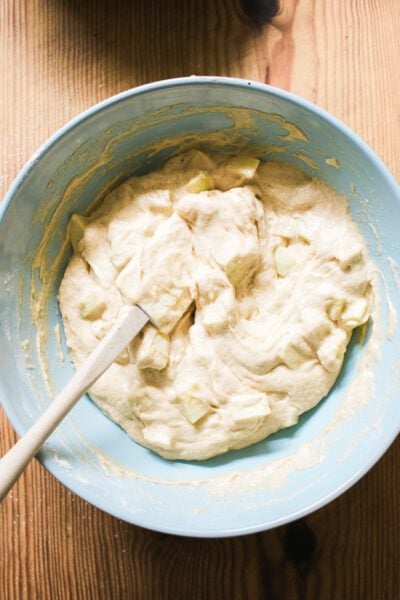 Mixed sourdough apple cake batter with chopped apples