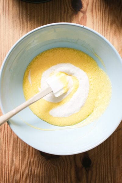 Creamed butter, sugar, eggs and sourdough starter in a large light blue bowl