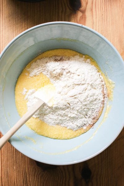Wet mixture and dry ingredients in a large light blue bowl