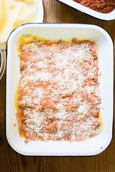 One layer of lasagna noodles w/ ragù sauce, béchamel sauce and ground Parmesan cheese
