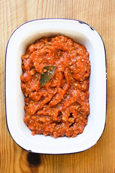 Ragù Bolognese sauce in a white enamel bowl