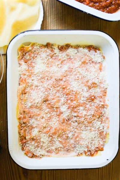Layer of lasagna noodles w/ ragù Bolognese sauce, béchamel sauce and ground Parmesan cheese