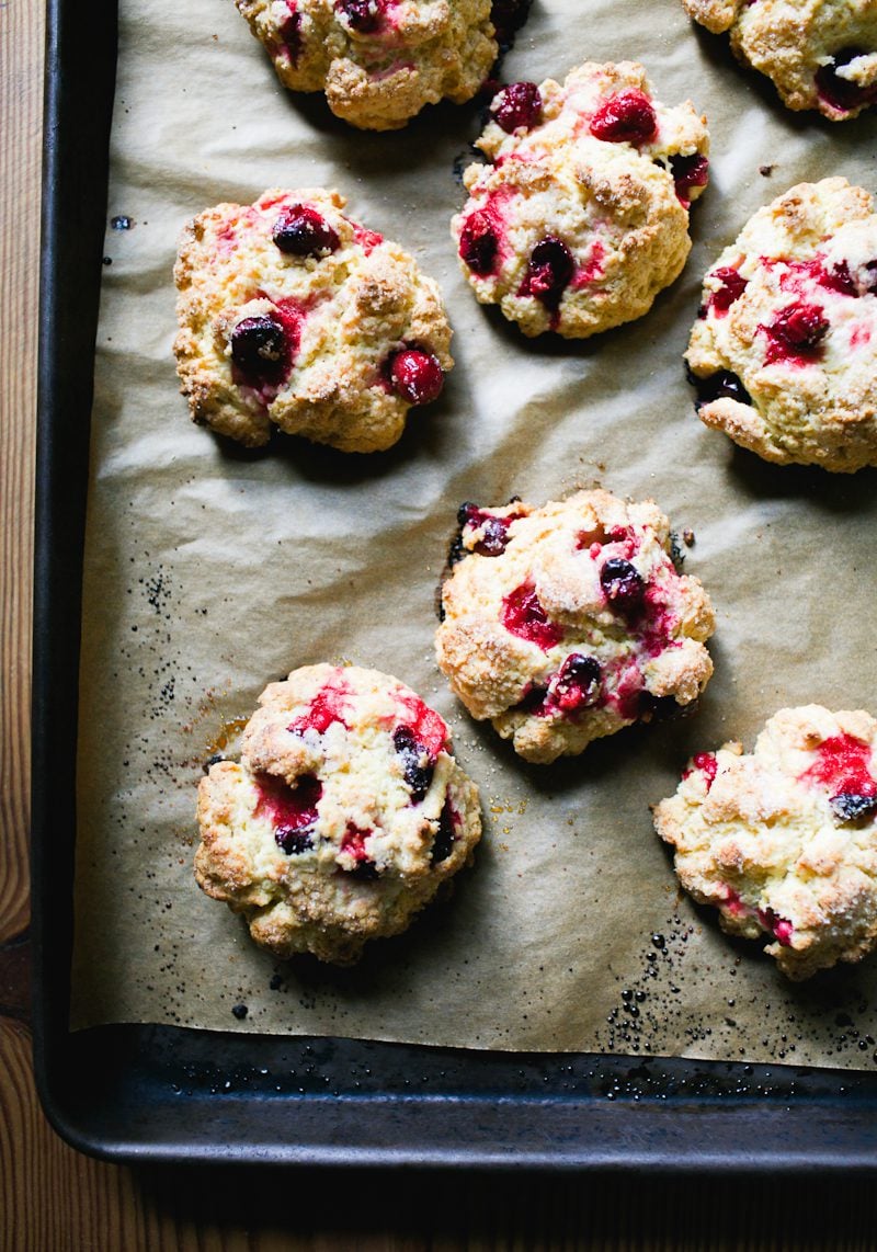 Sourdough scones with fresh cranberries and sparkling sugar on a baking sheet