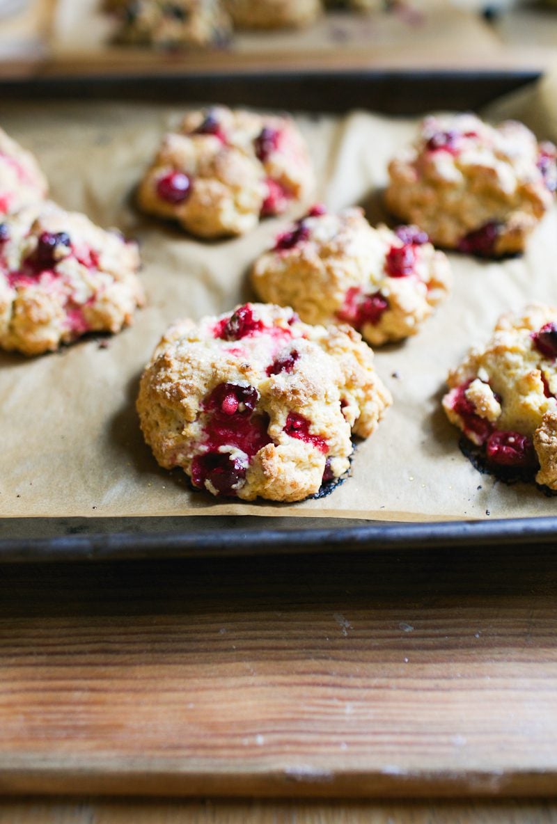 Sourdough scones with fresh cranberries and sparkling sugar on a baking sheet